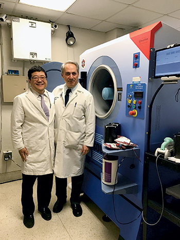 Dr. Jeffrey Jhang (left) and Dr. Jacob Kamen at Mount Sinai Hospital, where the Rad Source RS3400 x-ray irradiator (at right) was installed in January. “We were training, validating, and using the machine in February, and we went live on March 1,” Dr. Jhang says.