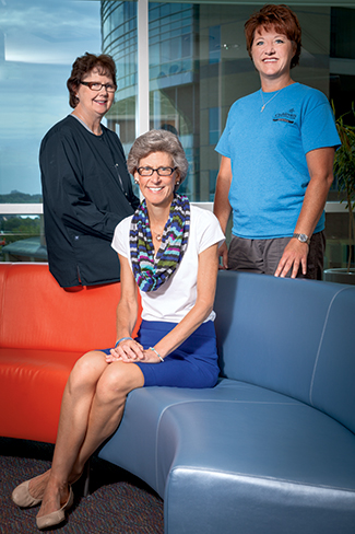 Donna Gombold (from left), Dr. Deborah Perry, and Melissa Irving-Gass at Children’s, where they set up a program to make sure the right genetic tests are ordered and no families are faced with unexpected costs. “We go back to the insurance companies three, four, five times to get the testing approved,” Gombold says.