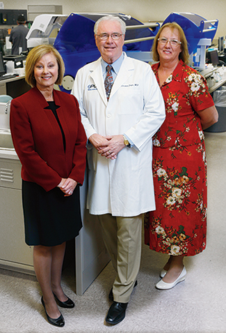 Dr. Dolan with Debbie Smith (left), director of the Enterprise Data Warehouse, and Debbie McClain, director of operations process improvement. RML has averaged about a three percent productivity increase per year for 11 years (measured by billed units per FTE), some of which is due to growth and economies of scale but much of it, they believe, due to improving process.