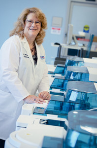 Dr. Wilkerson in front of the Roche 8000, which is connected by the new Roche 8100 automation line to the Sysmex hematology and Stago coagulation analyzers.