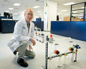 The floor is raised 18 inches to allow plumbing and electrical and other lines to run beneath it, Dr. Schuerch demonstrates, making architectural modification unnecessary even as the laboratory’s needs change.