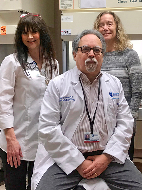 Sherry Childress (left) and Dr. Gail Woods with Dr. José Romero at Arkansas Children’s. “I think everyone around the country has been surprised by the number of cases we’re seeing,” Dr. Romero says.