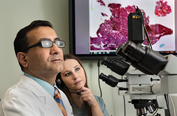 Dr. Anil Parwani (left) with Juliet Filter, PA(ASCP). “Using speech-recognition software helps my workflow,” says Filter, who used a Dictaphone earlier in her career. “It is much more highly effective—examining your dictation immediately on a computer screen rather than hours later, after it has been transcribed.”